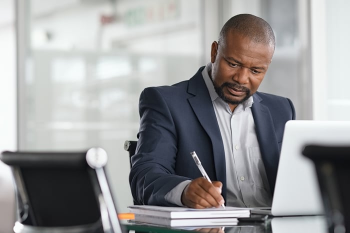 A person at a desk taking notes.