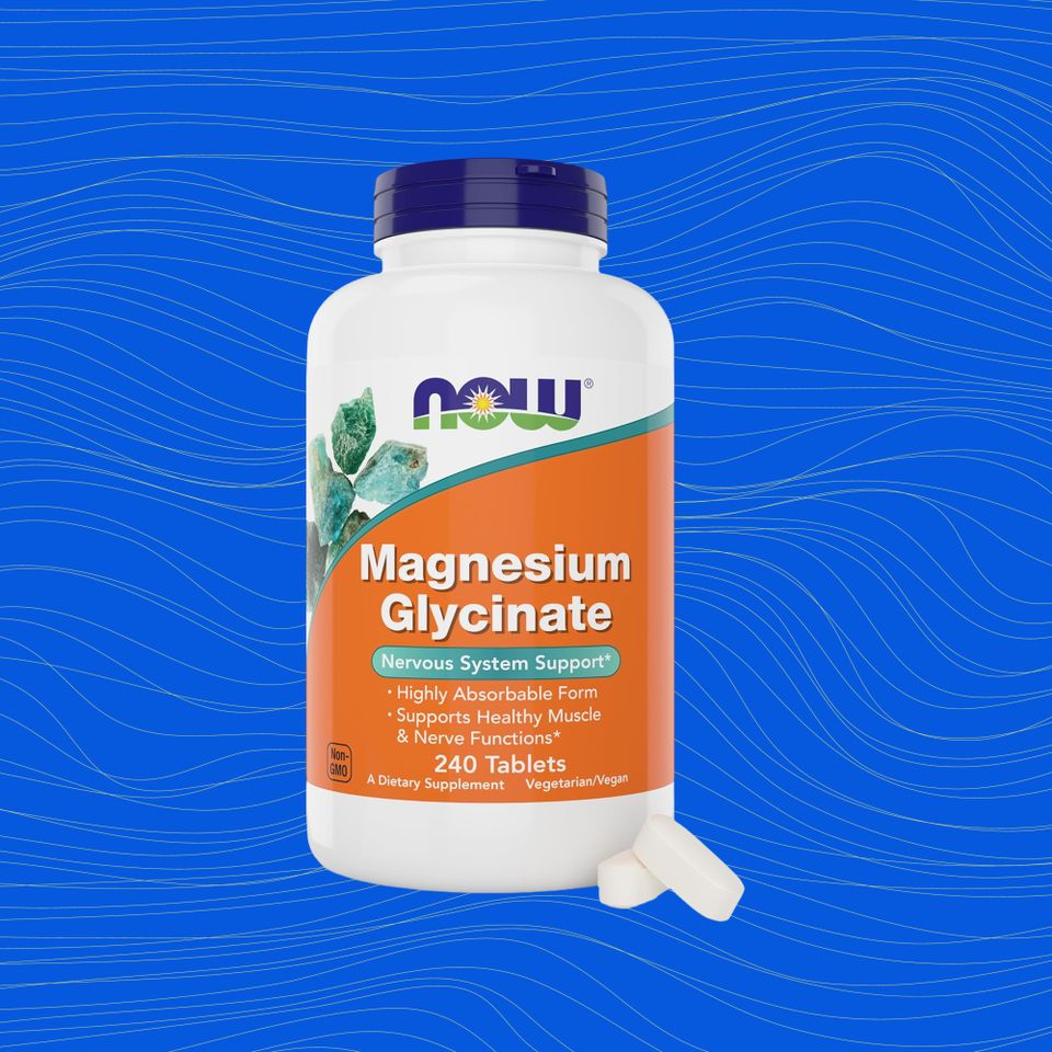 A bottle of magnesium glycinate supplement on a blue background