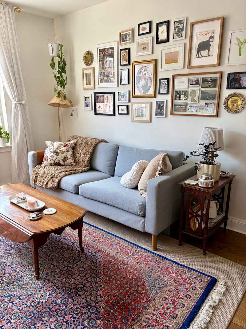 Cozy living room with a gray sofa, patterned rug, round brown chair, and a wooden coffee table.