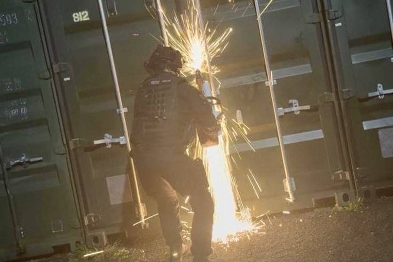 Police break open secure container and discover major haul inside