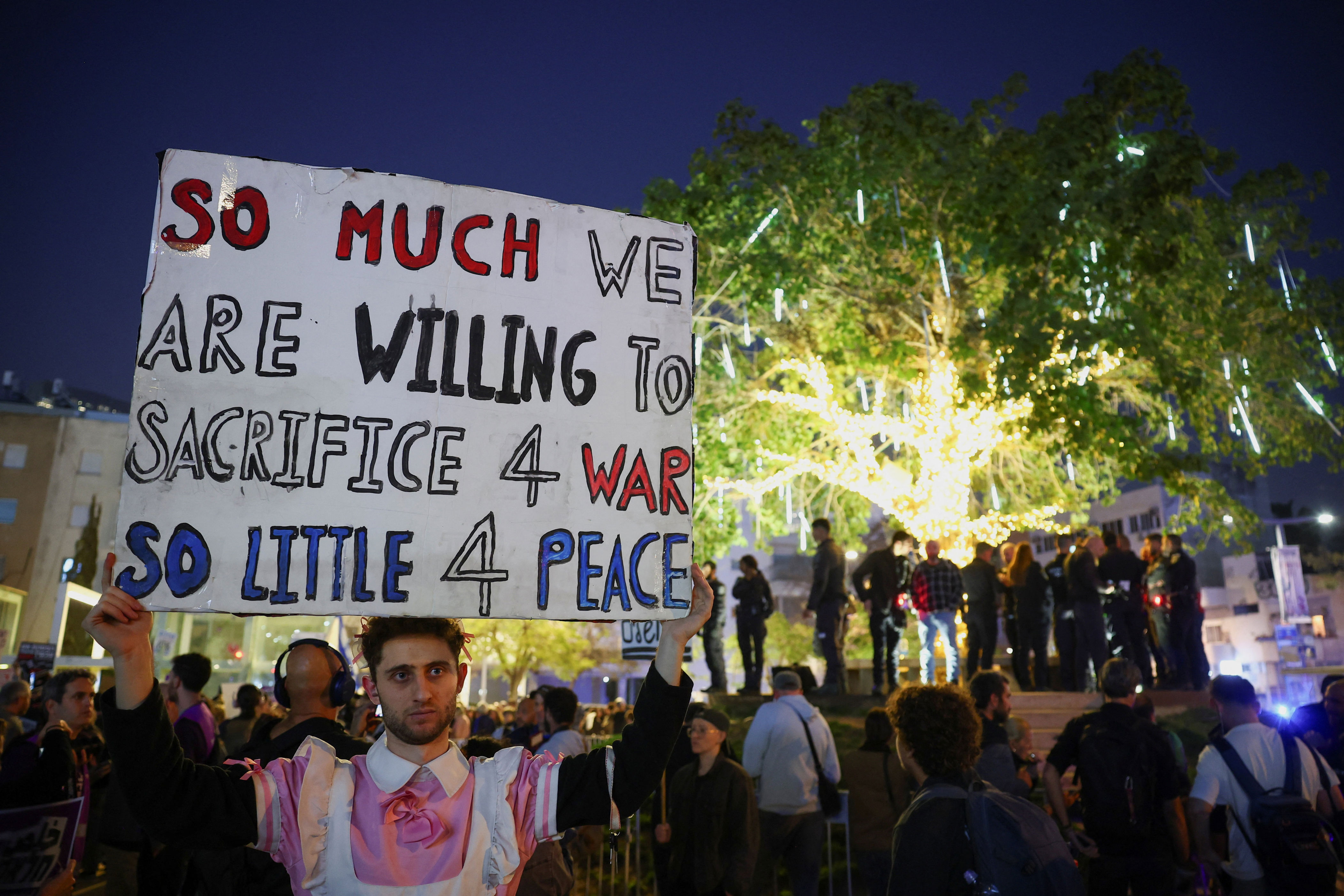 A demonstrator holds up a sign during an anti-war protest calling for an end to the U.S.-Israel conflict with Iran, in Tel Aviv, Israel, April 4, 2026.