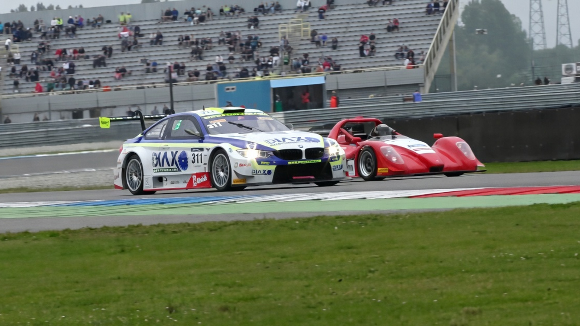 A tight racing moment in the corner between BMW and prototype car