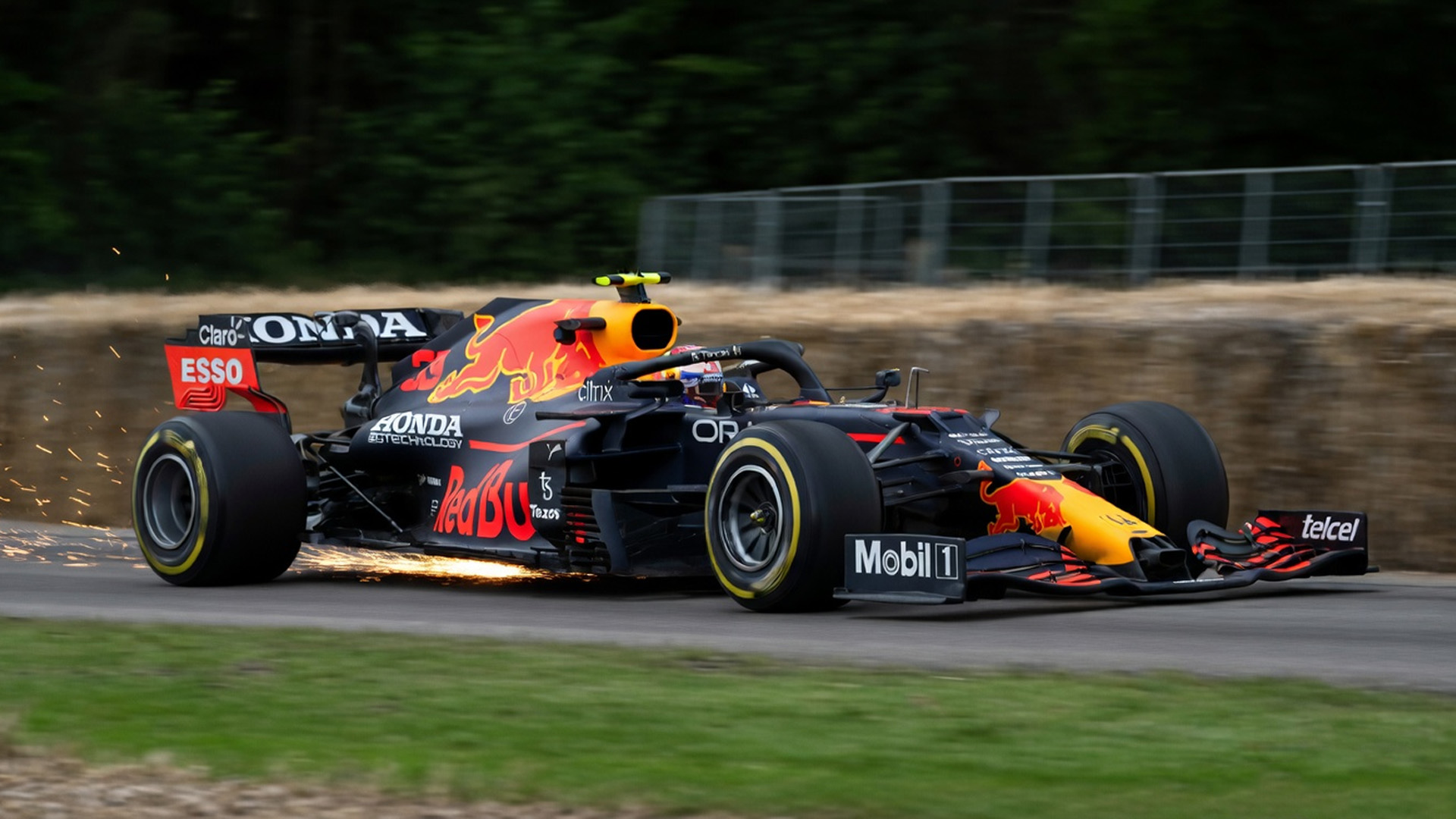 Red Bull F1 car scrapes sparks through fast corner