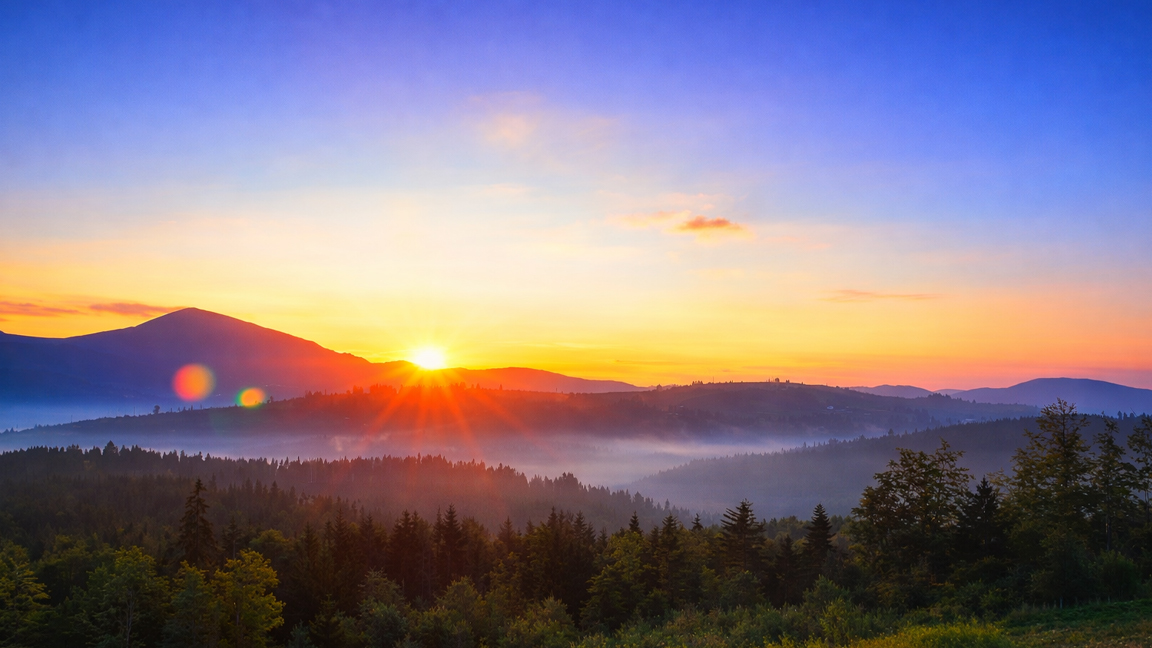 peaceful-morning-landscape-with-sun-rising-behind-the-mountains