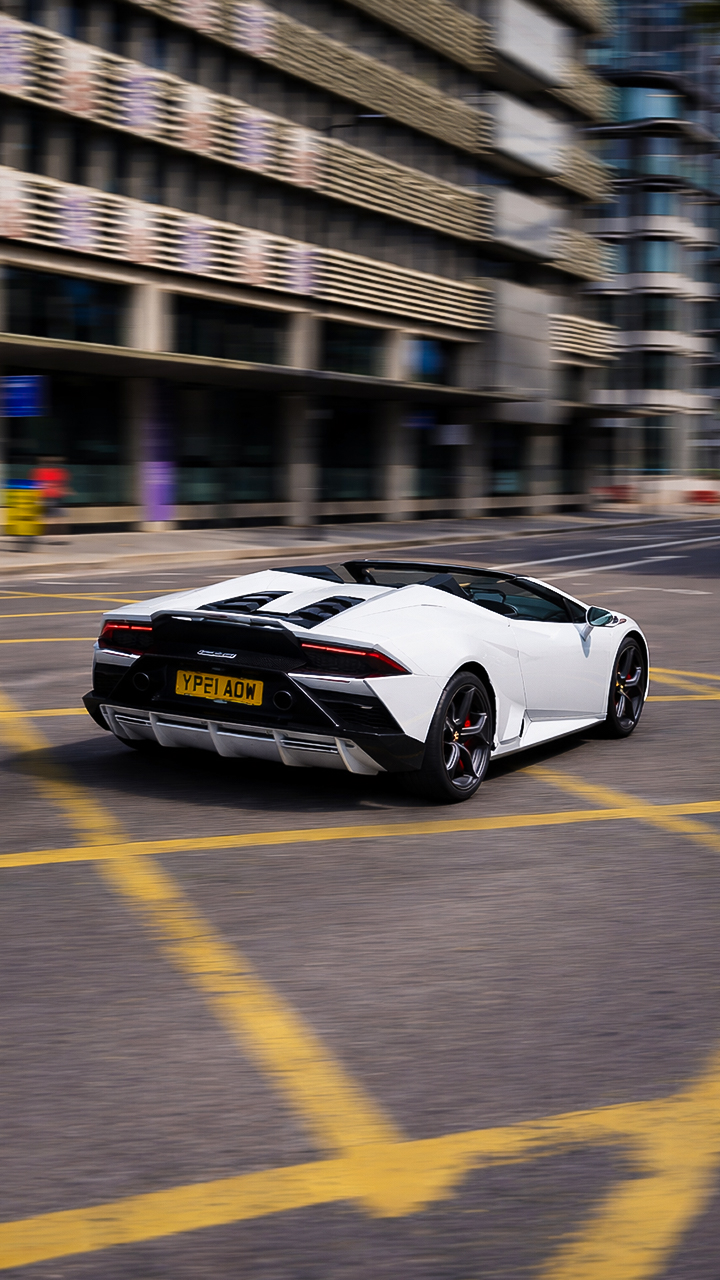 White Lamborghini Huracan moves fast on road