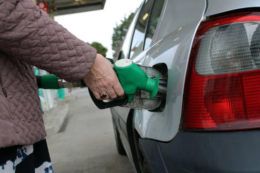 Close-Up of Hand Holding Fuel Pump Nozzle Refueling Car at Petrol Station - Gasoline, Energy and Transportation