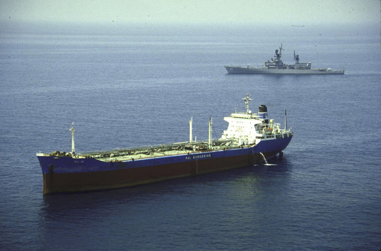 A U.S. warship escorted a reflagged Kuwaiti tanker through the Gulf of Oman in 1987.