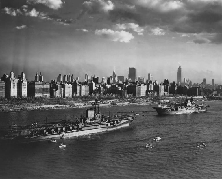 Aircraft carriers passing the Manhattan skyline in 1945.