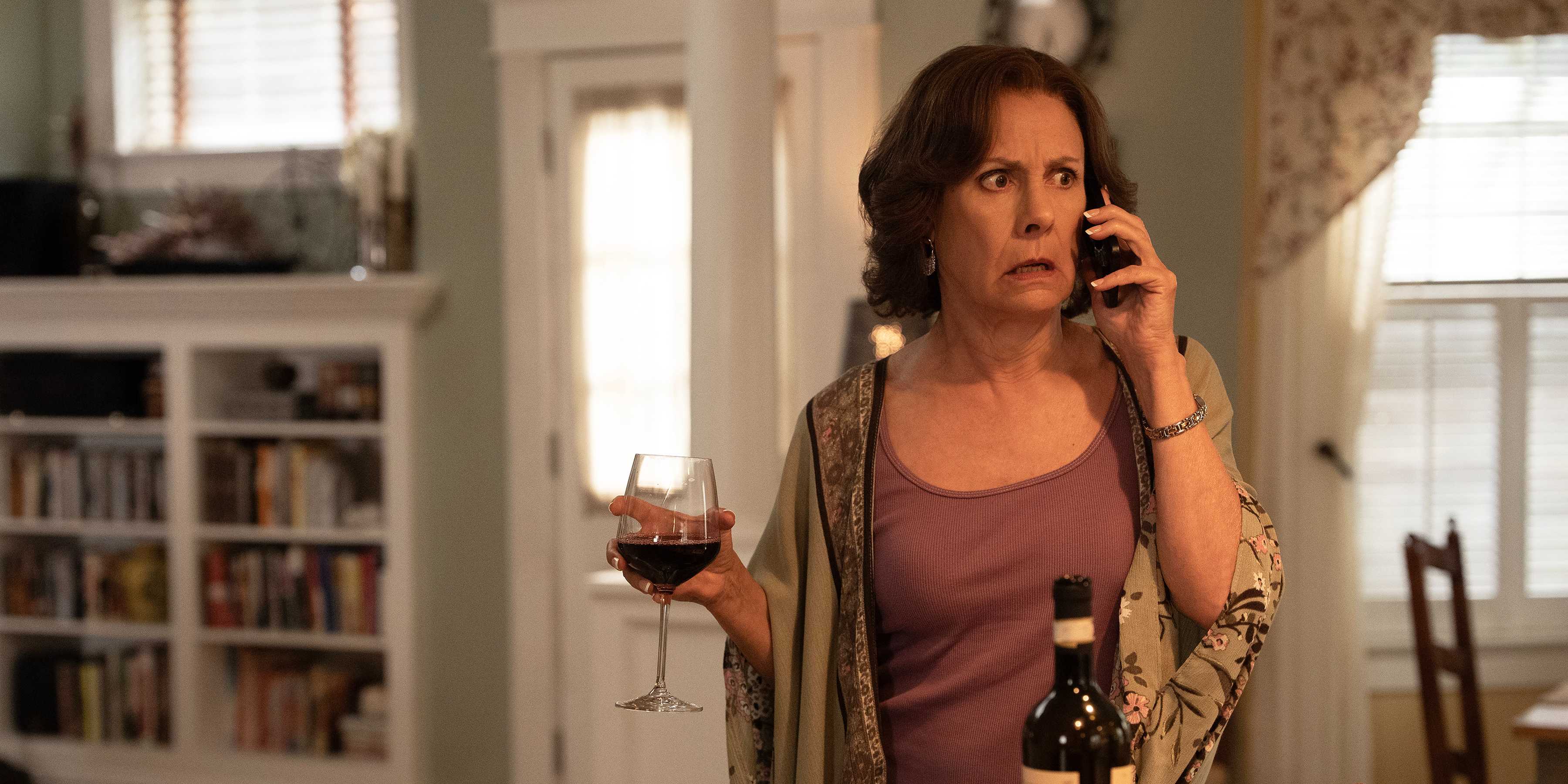 Laurie Metcalf drinking wine looking shocked in Big Mistakes