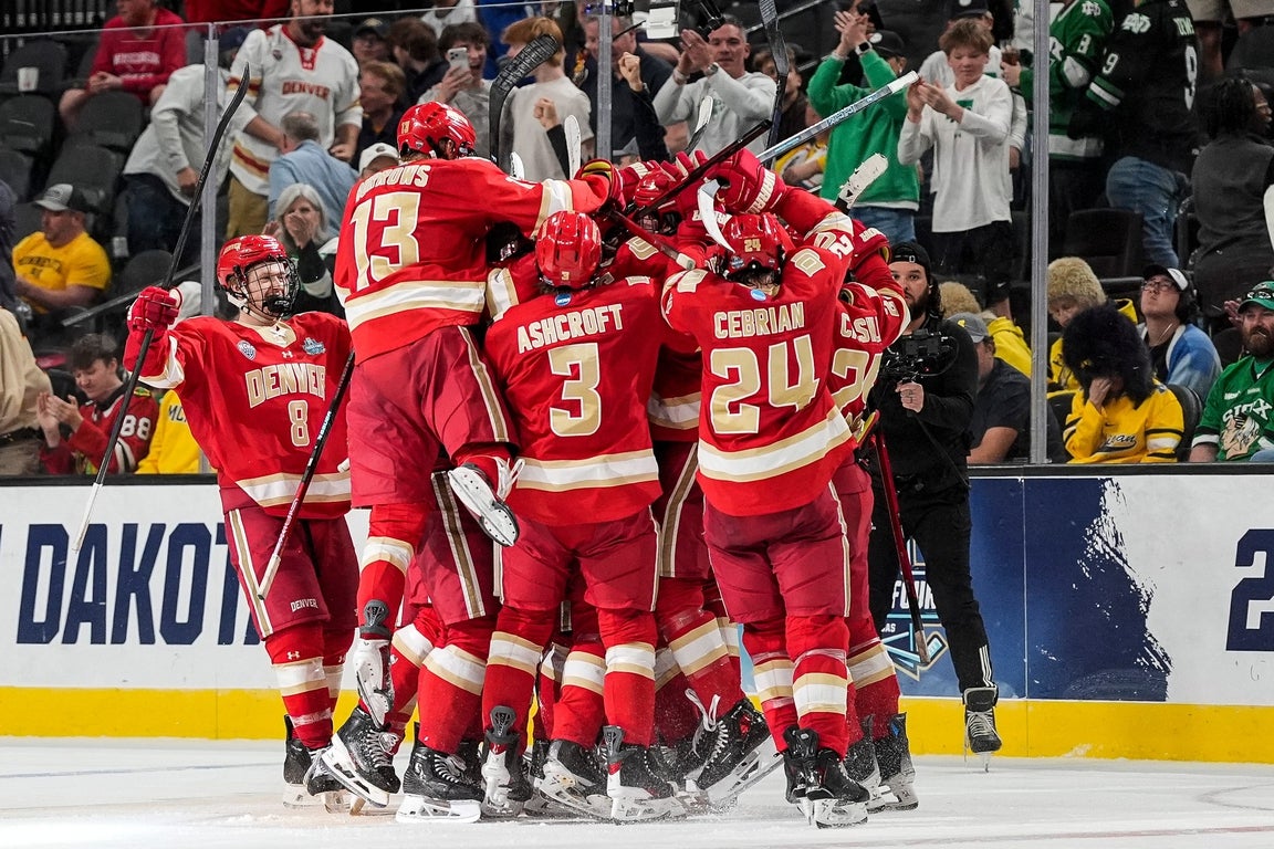Denver players celebrate dramatic 4-3 double-overtime win over Michigan ...