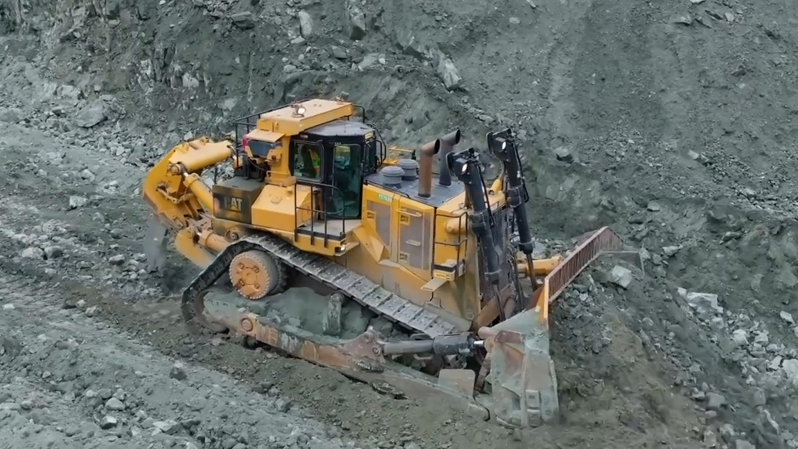 This giant machine moves heavy material with steady force