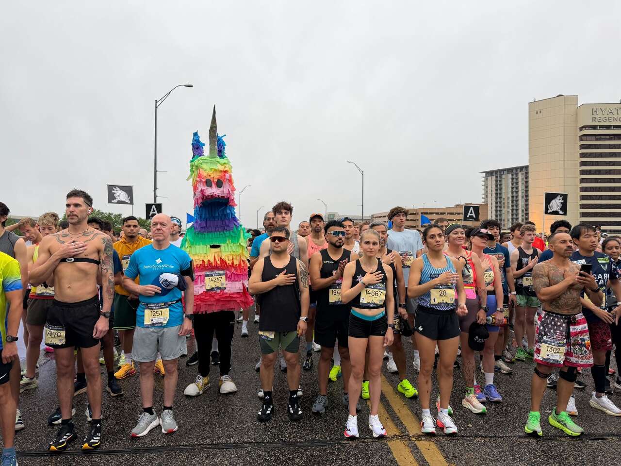 Rainy conditions greet runners at 2026 Statesman Cap10K. See photos