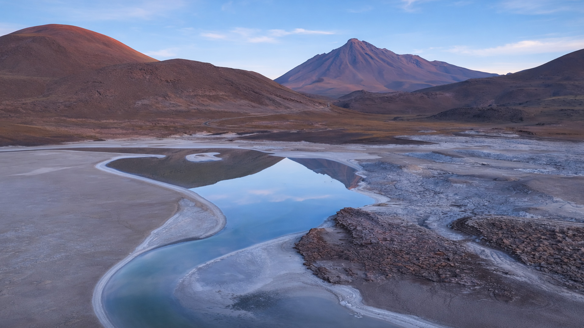 This lake reflects the desert mountains