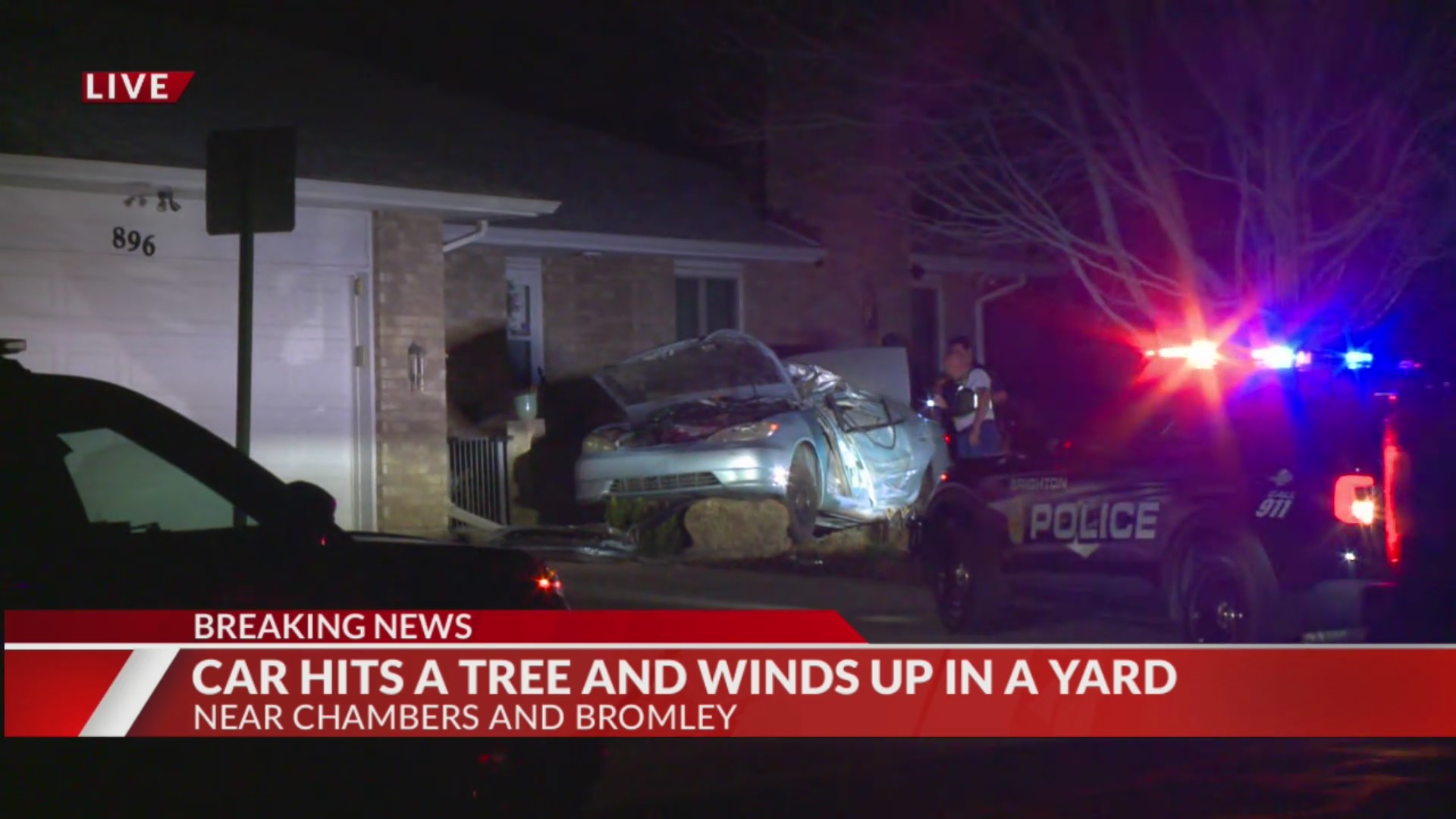 Car hits tree, ends up in yard of Brighton home