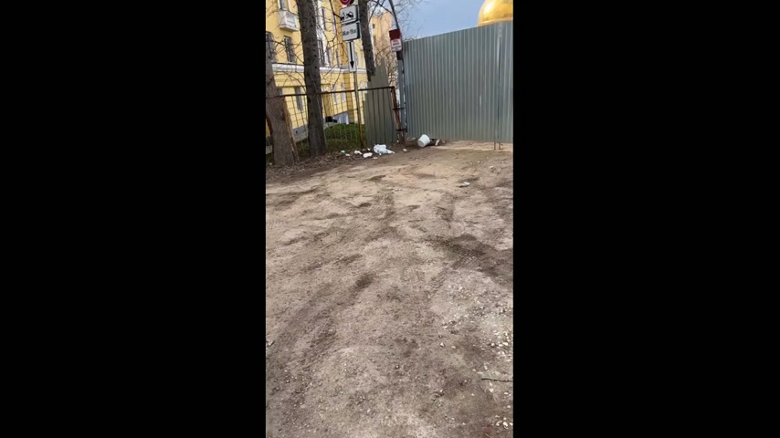 Dog drags bucket through gate and across yard in Samara, Russia