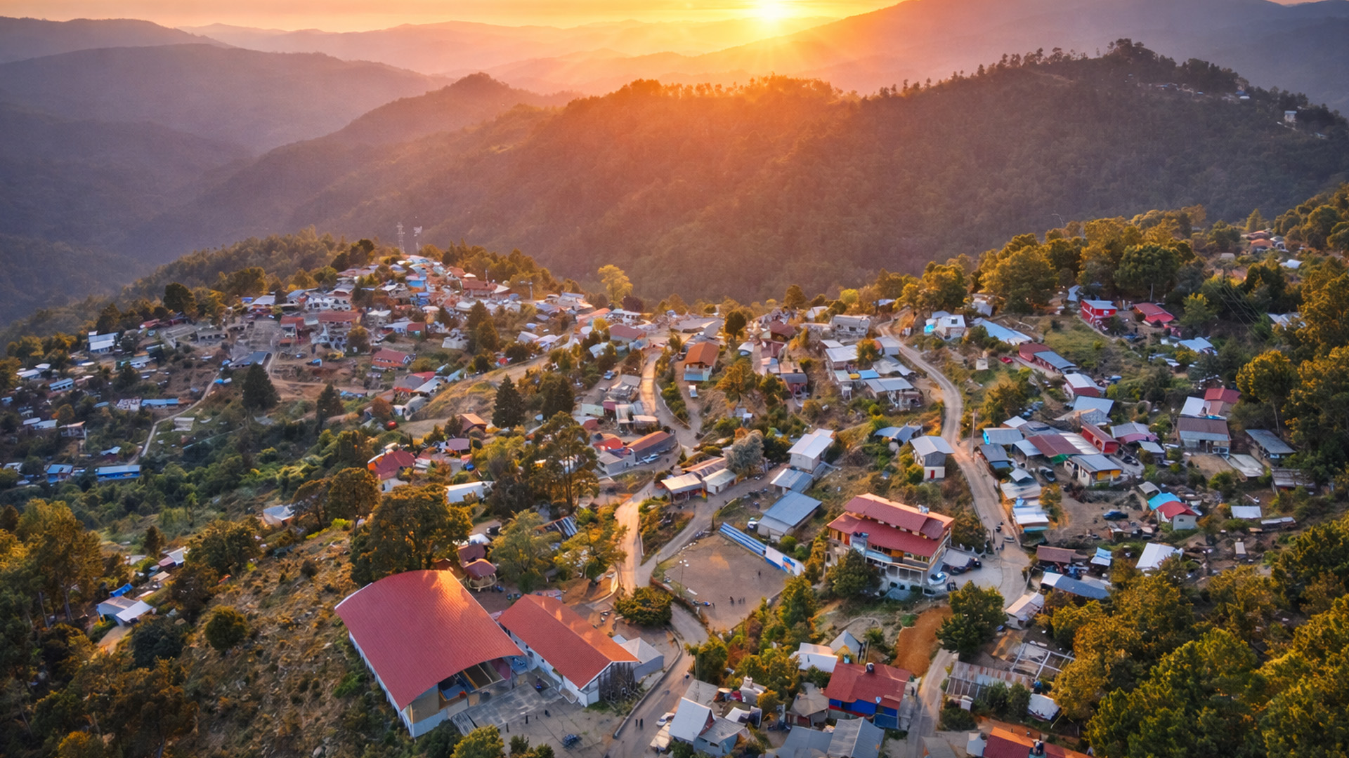 A mountain town covered in golden sunset light