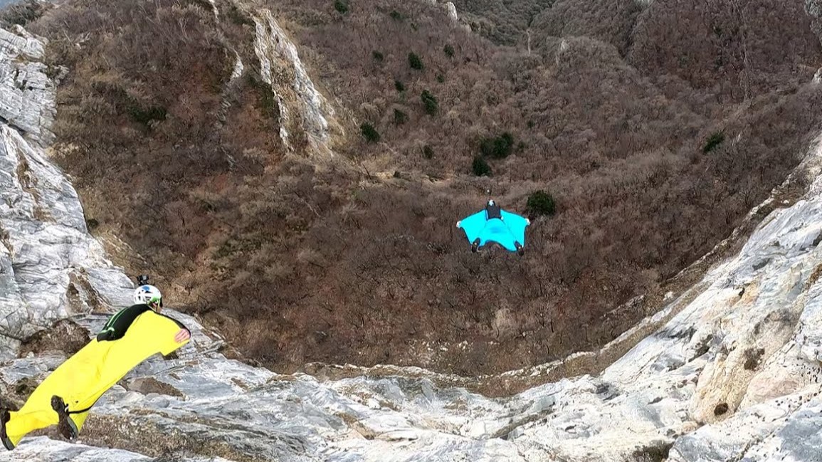 They jumped along a razor-thin ridge - then flew side by side