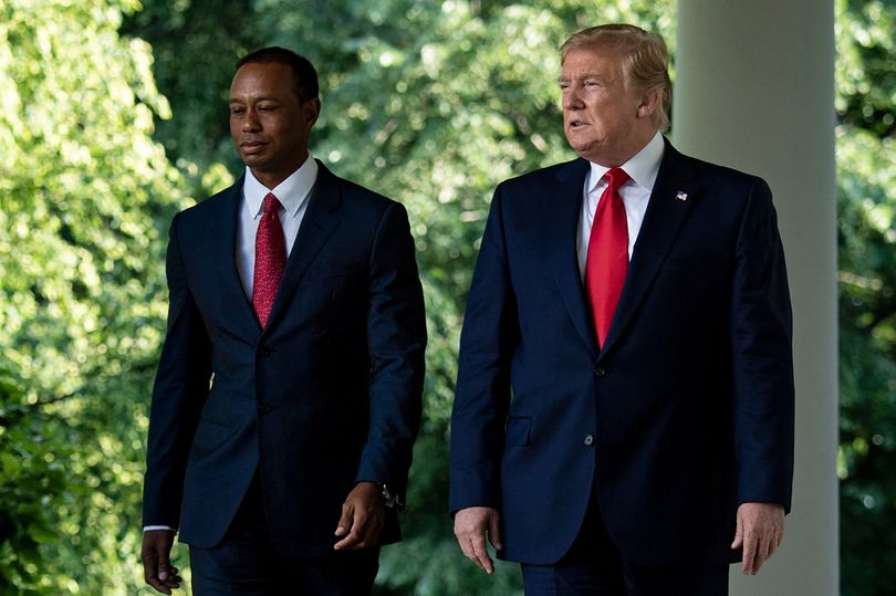 US President Donald Trump and professional golfer Tiger Woods walking together