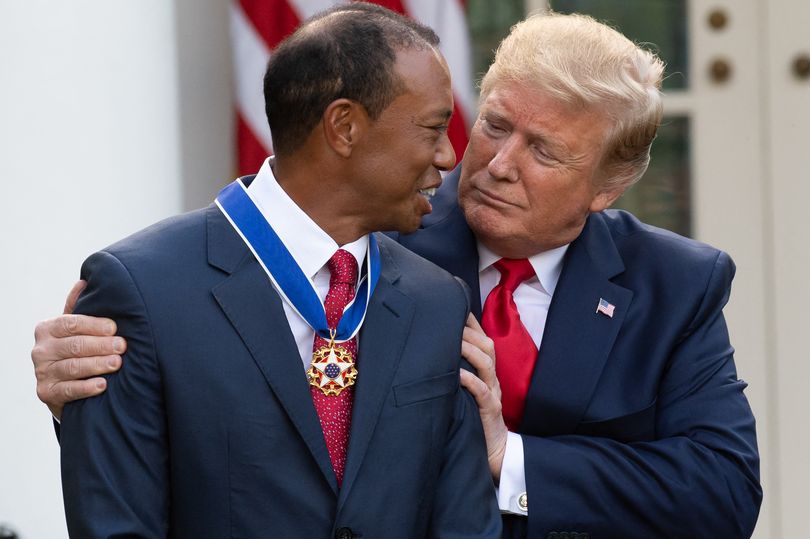 US President Donald Trump presents US golfer Tiger Woods with the Presidential Medal of Freedom