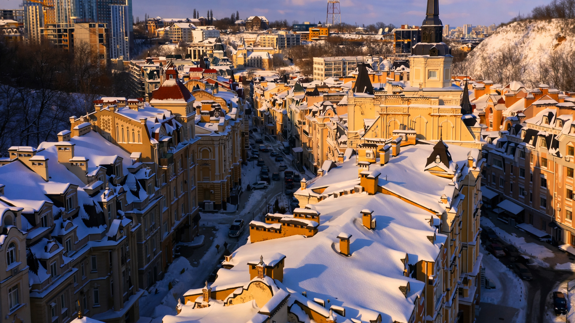 Peaceful winter city with snow covered rooftops and soft sunlight