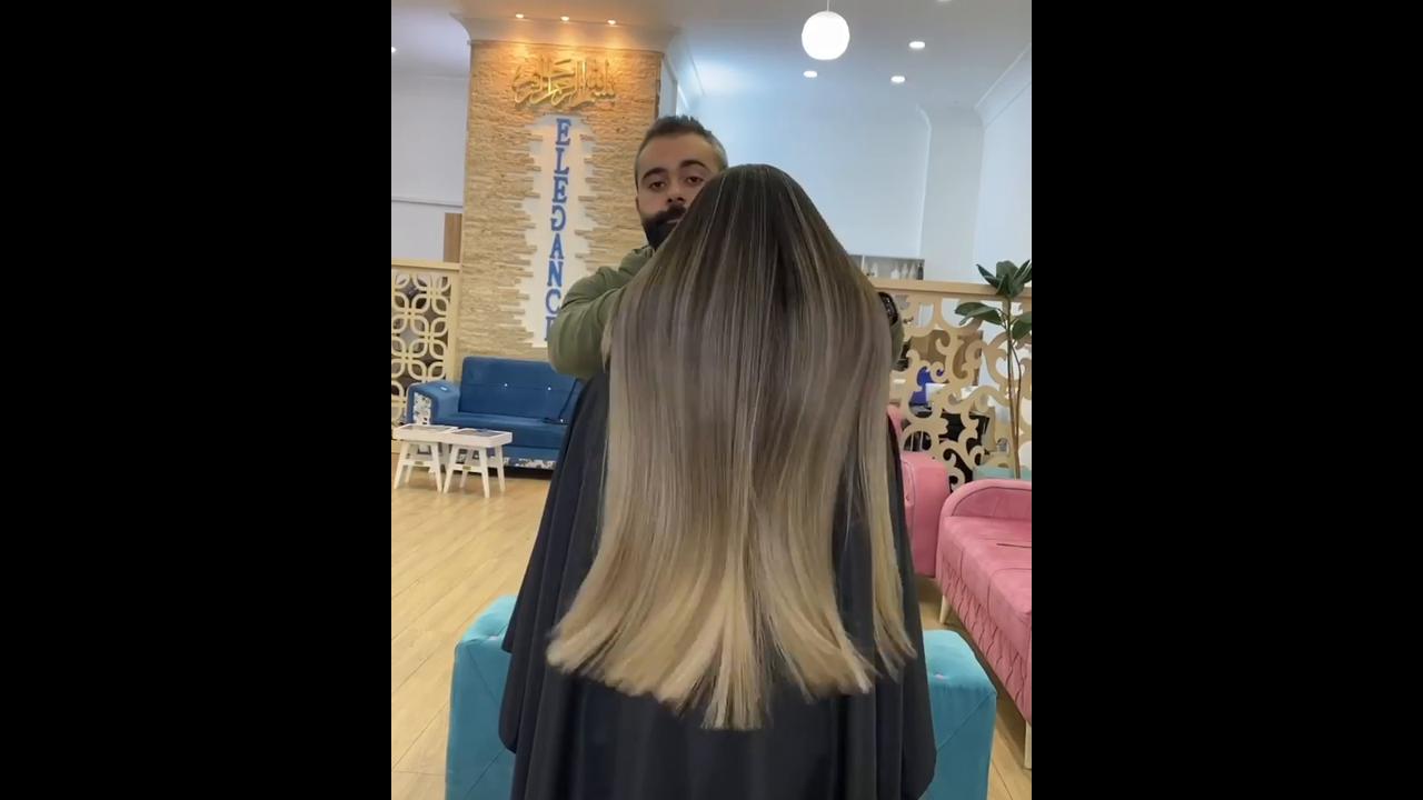 Styling ultra long hair with flat iron technique producing glossy ...