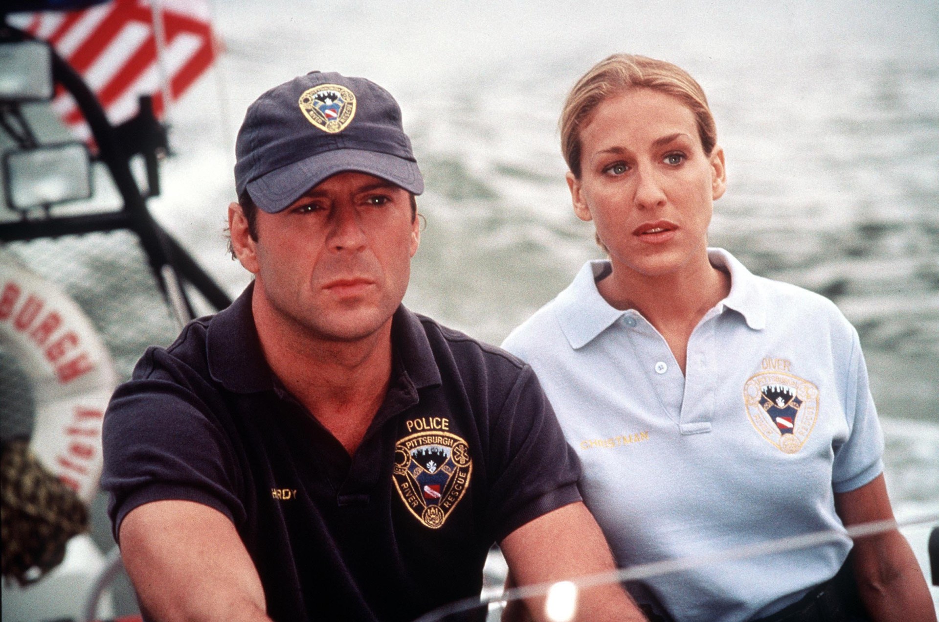 The polo shirt is a step up from John McClane’s usual dirty vest, but you can tell that Carrie Bradshaw isn’t happy about having to wear one (Picture: Channel 5)