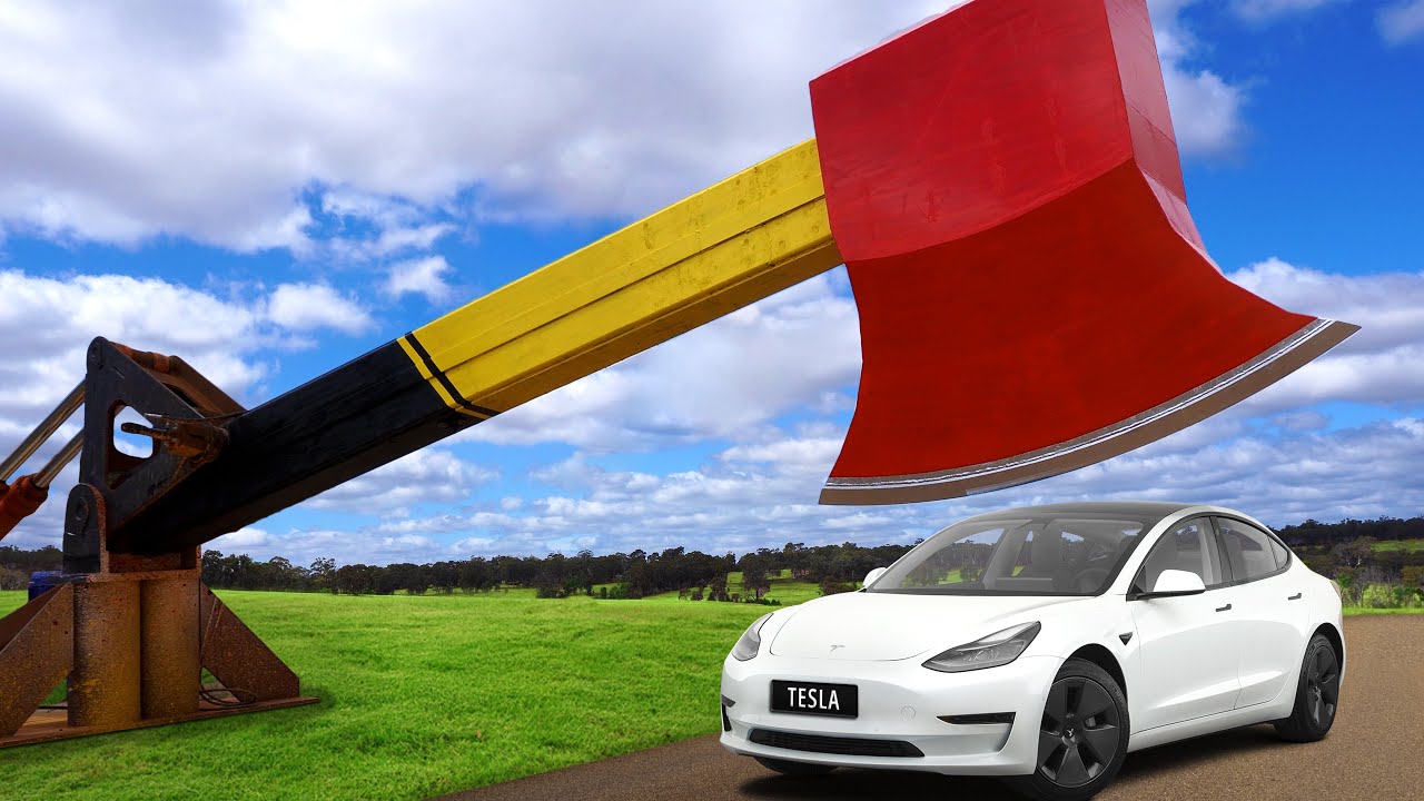 Watch what happens when a giant axe chops a Tesla