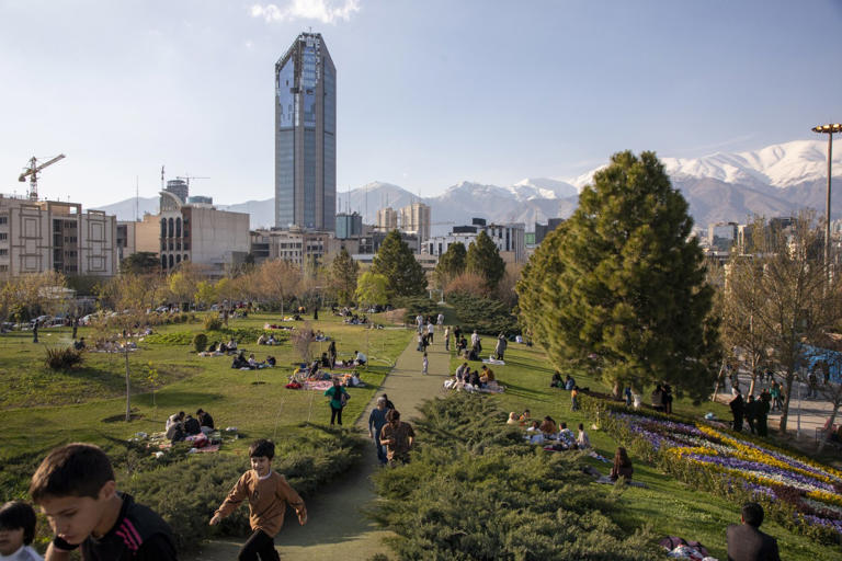 Iranians flood a park April 2 in Tehran.