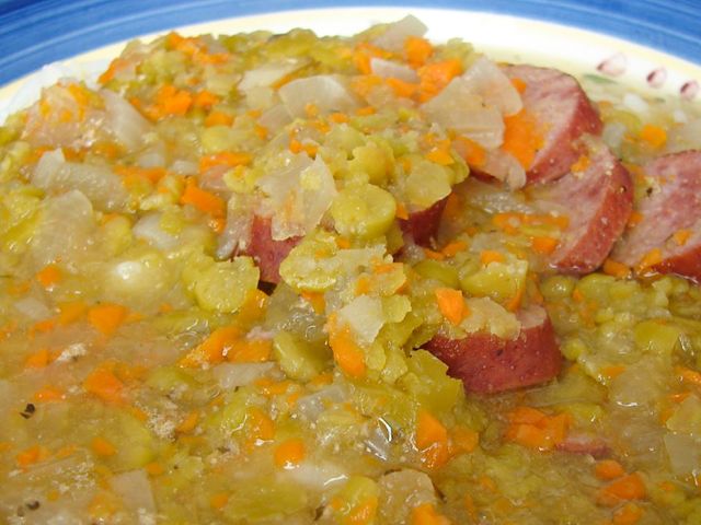 close up view of Split Pea Sausage Soup with carrots and onions in a bowl