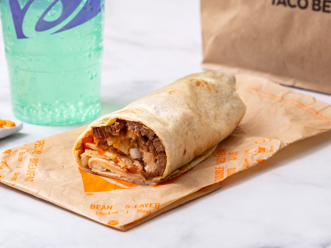 A Taco Bell supreme steak burrito, with a Mountain Dew Baja Blast soda