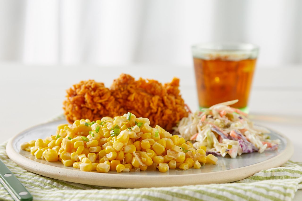 Southern Living Southern Fried Corn on a plate with fried chicken and slaw