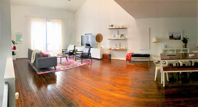 Living room with hardwood flooring before makeover