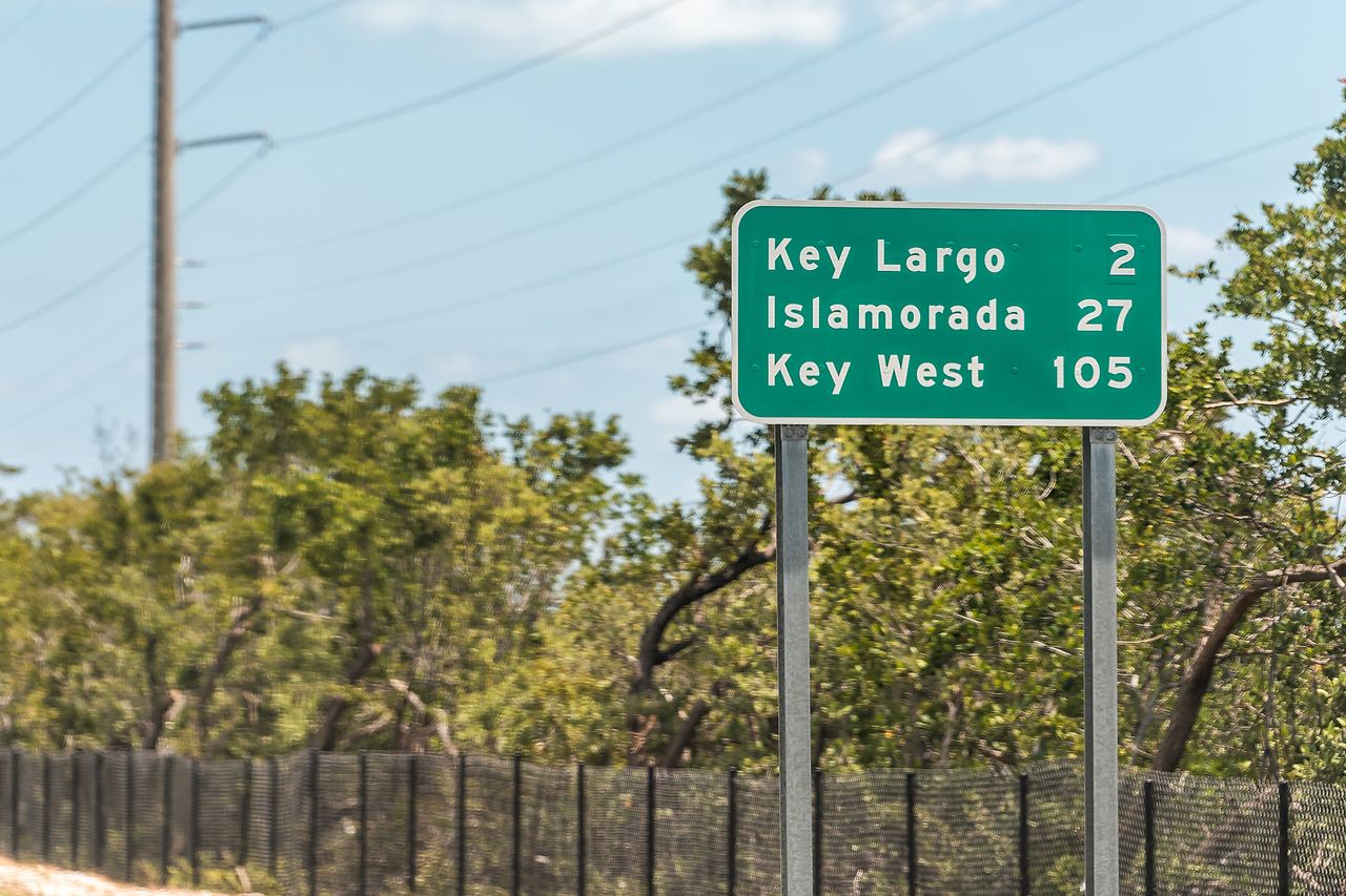Road sign displaying distances to Key Largo Islamorada and Key West