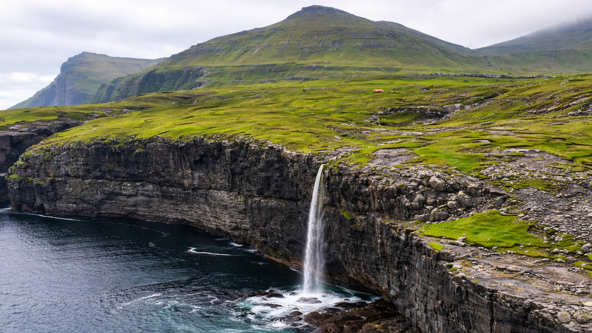 A waterfall hanging over a coastal drop
