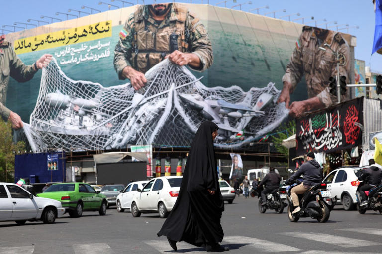 A billboard in Tehran depicts soldiers trapping U.S. military equipment in a net.