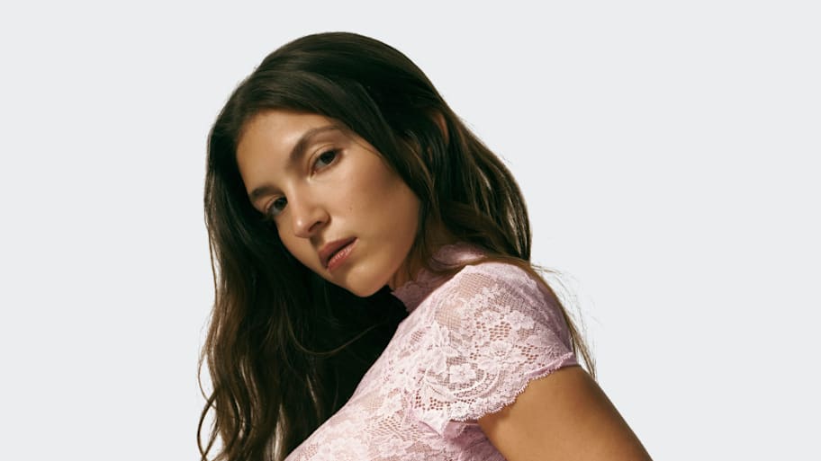 Sydney Sweeney styles pink lace tee from her SYRN line with denim for ...