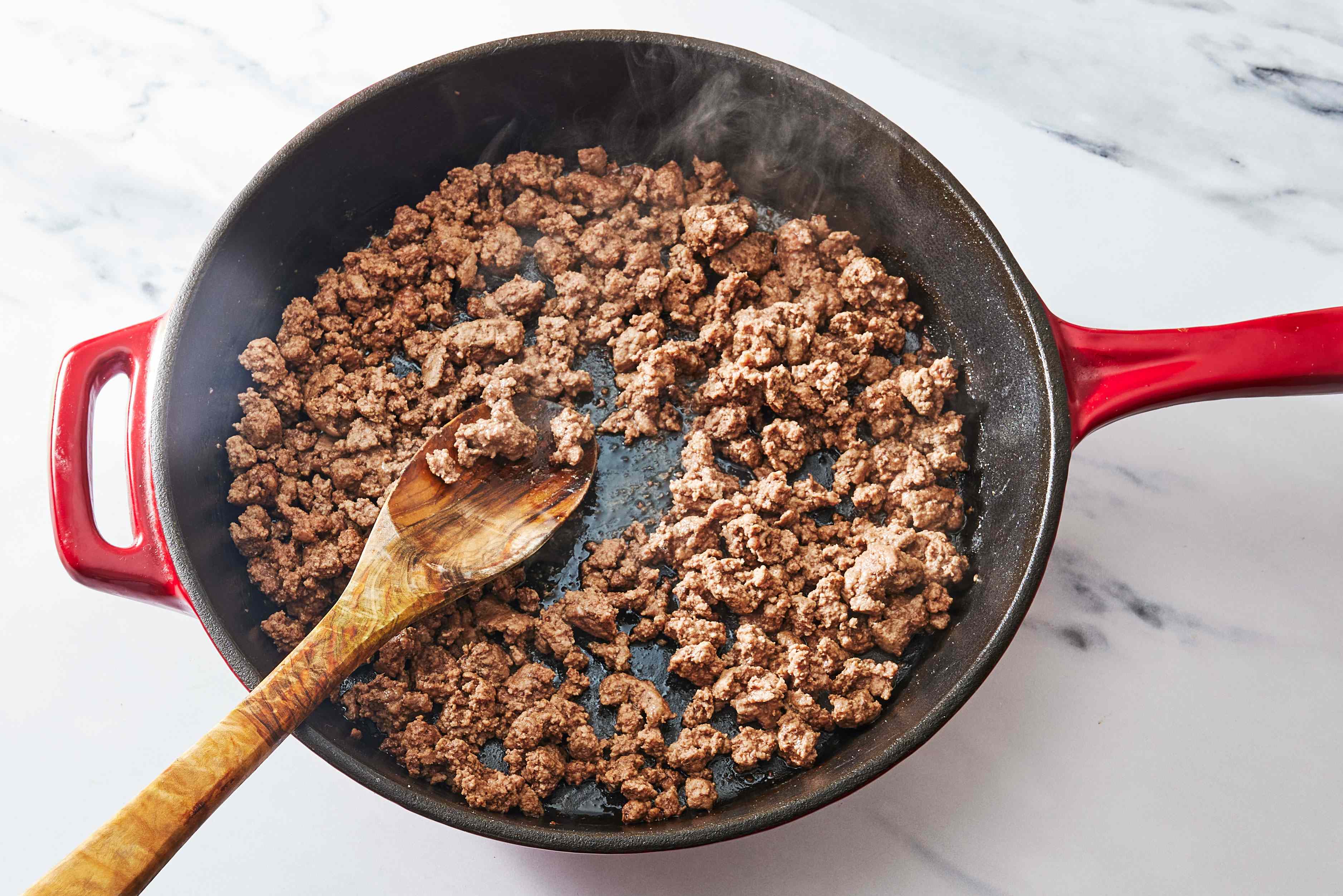 Is it safe to use the same utensil for raw and cooked meat?