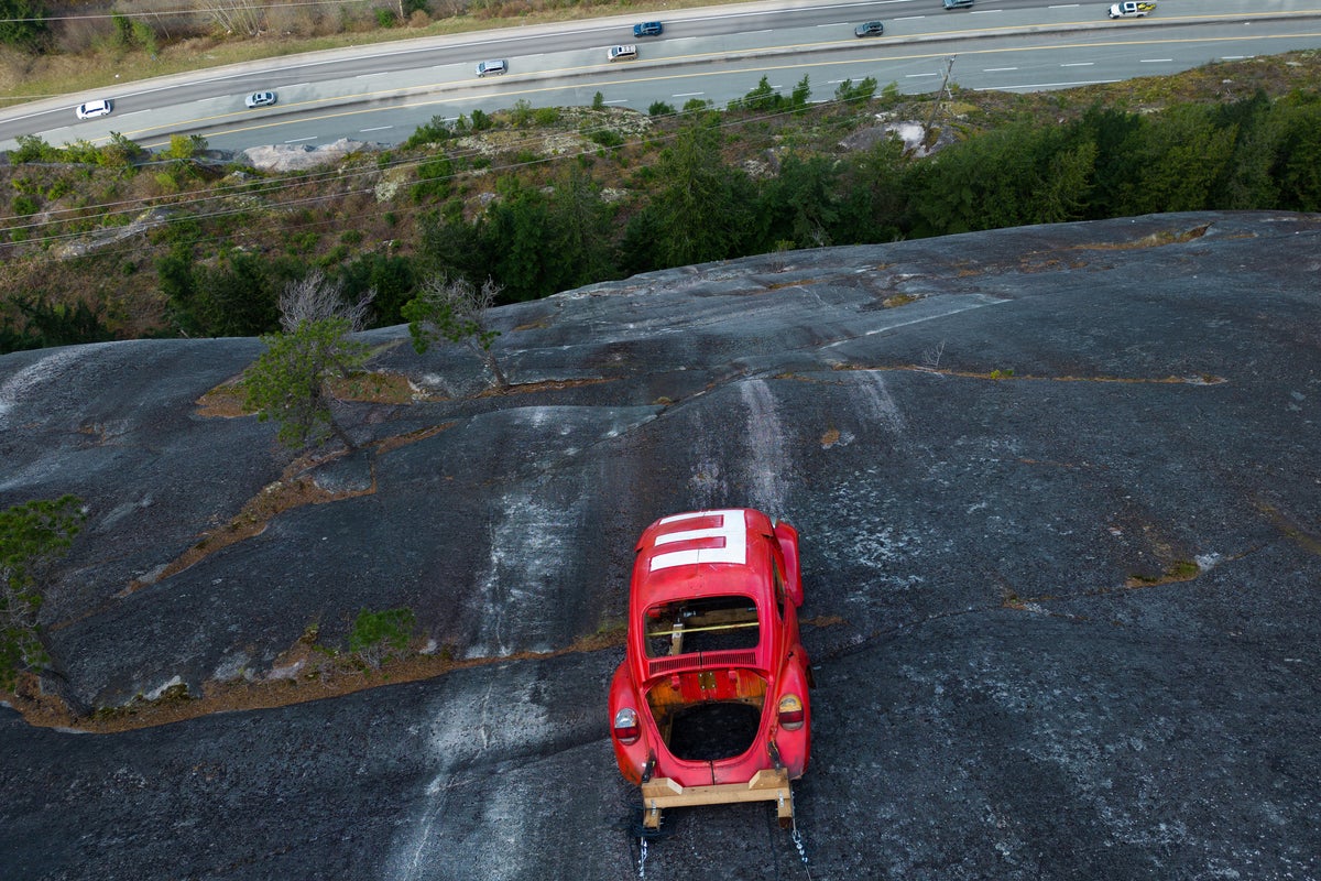 Public warned to stay away from car suspended on rock face
