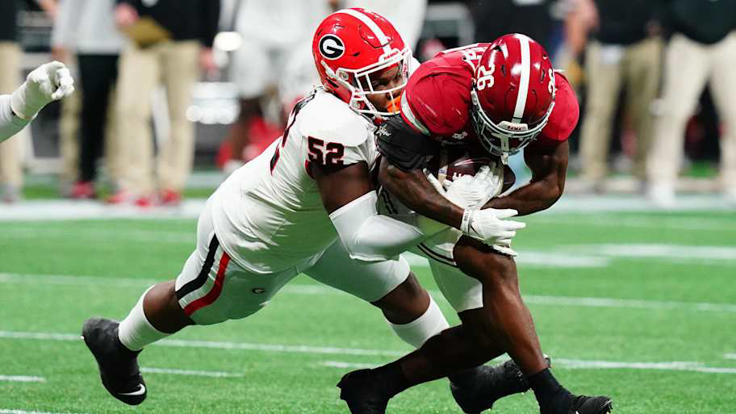 Georgia Bulldogs defensive lineman Christen Miller (52) tackles Alabama Crimson Tide running back Jam Miller (26) in the first quarter of the SEC Championship at Mercedes-Benz Stadium. | John David Mercer-Imagn Images