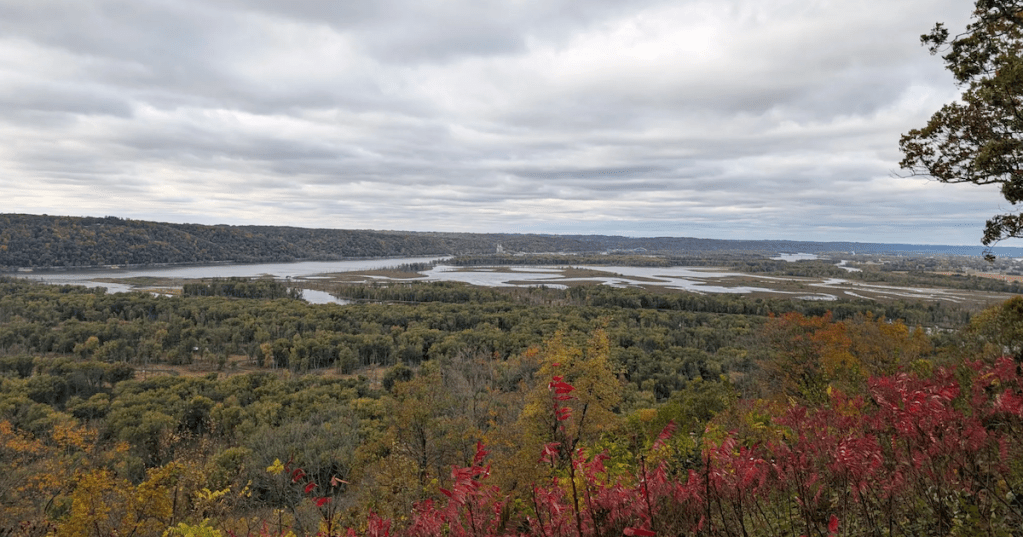 High bluff overlook at Wyalusing State Park, WI, showing vibrant autumn colors and river valleys.