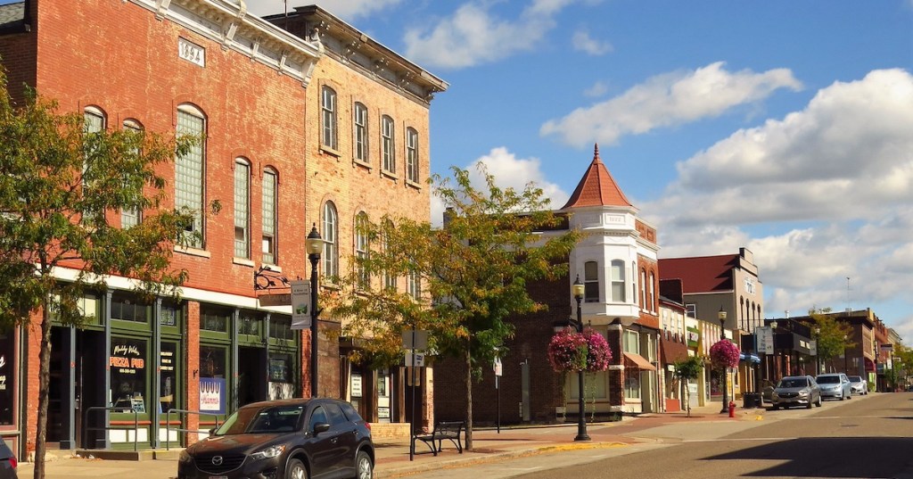 Historic brick buildings and local shops along a sunny street in downtown Prairie du Chien, WI.
