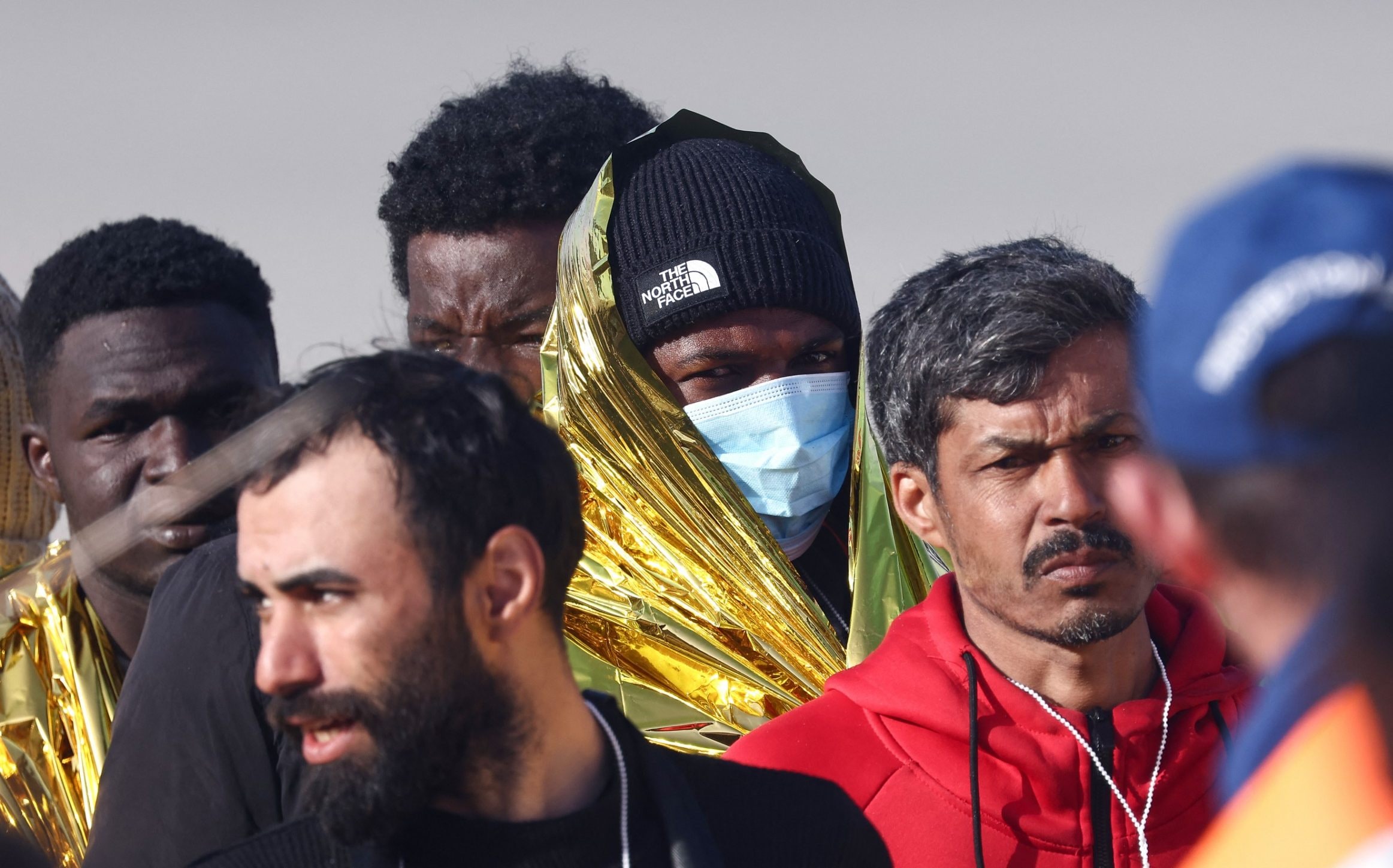Rescue units help migrants who survived the sinking of their dinghy just off the coast of Boulogne - Sameer Al-Doumy/AFP