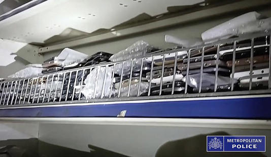 Footage released by police shows shelves of 'stolen' mobile phones at a convenience store in north-west London 