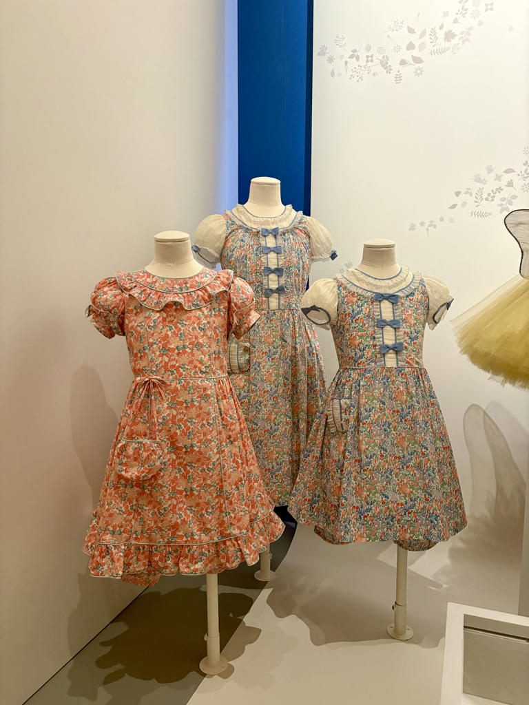 Princess Elizabeth and Princess Margaret's Liberty style dresses on display at Buckingham Palace. (Image credit: Christine Ross)