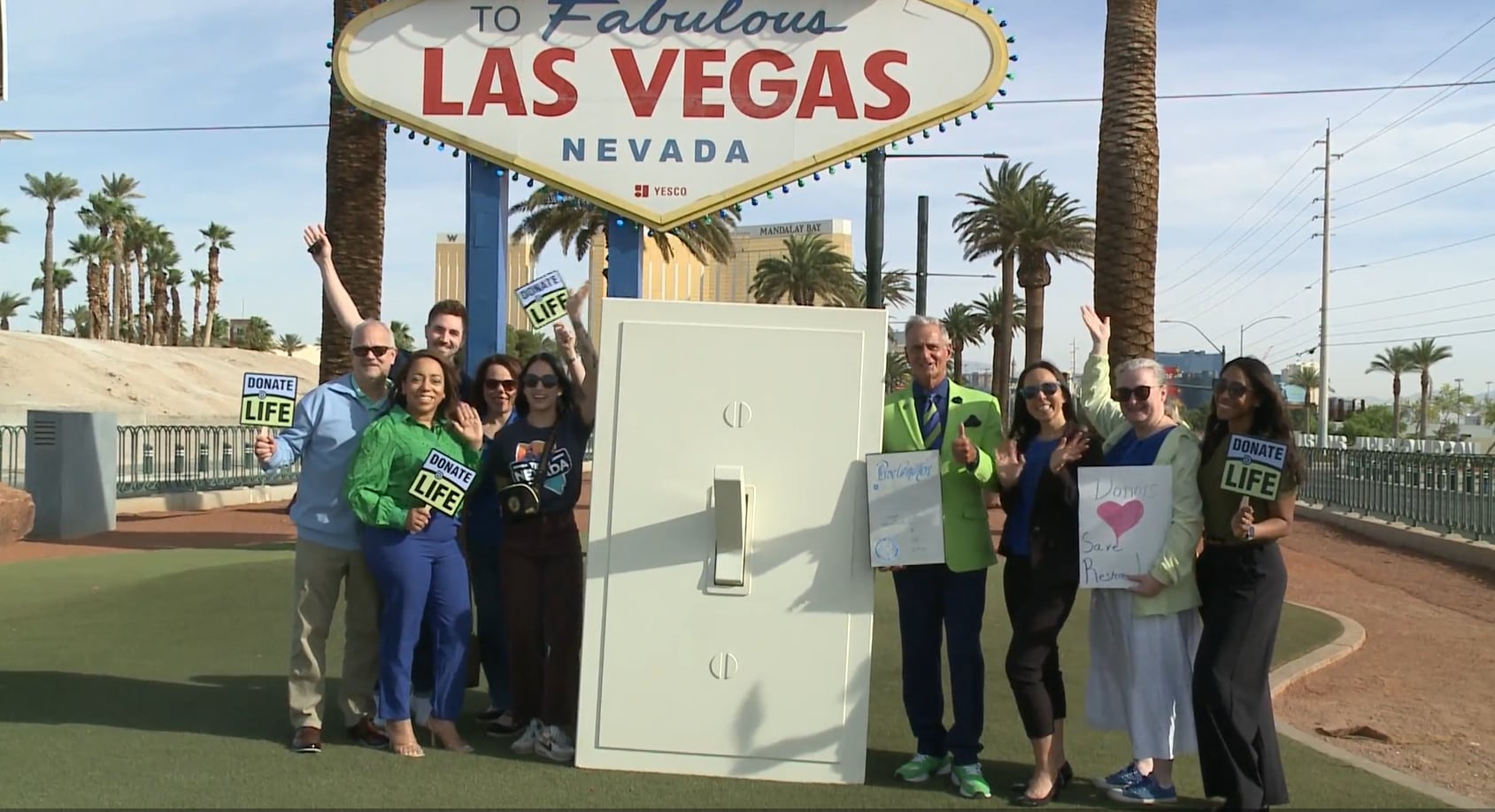 Welcome to Las Vegas sign lit blue, green for Donate Life Month