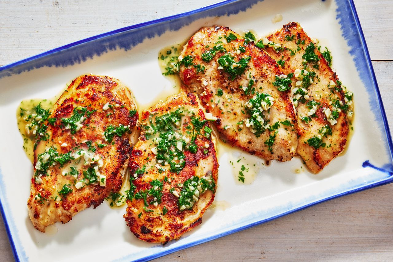 Southern Living Garlic Butter Chicken on a platter to serve topped with sauce