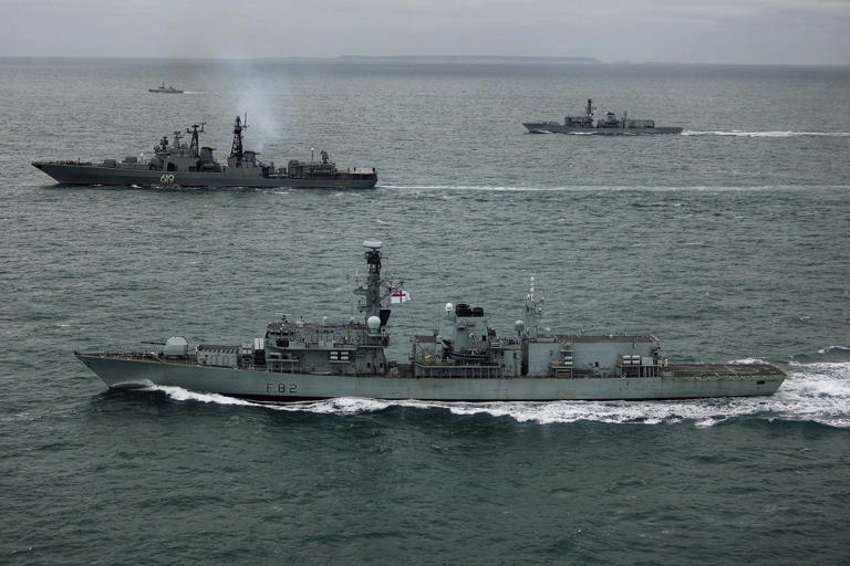 Royal navy ships HMS 'Somerset' (front), and HMS 'St Albans' tracking a Russian vessel (centre) in UK waters (Photo: PA)