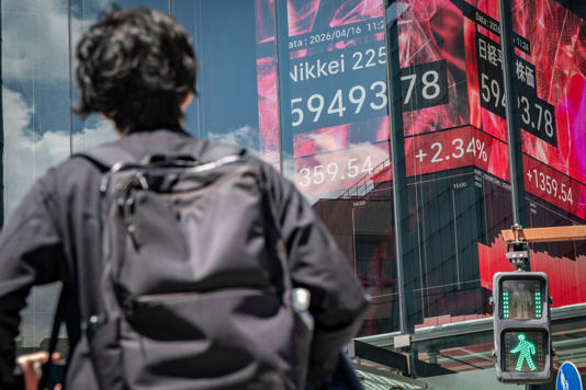 A man looks at an electronic quotation board displaying the Nikkei Stock Average on the Tokyo Stock Exchange (AFP/Getty)