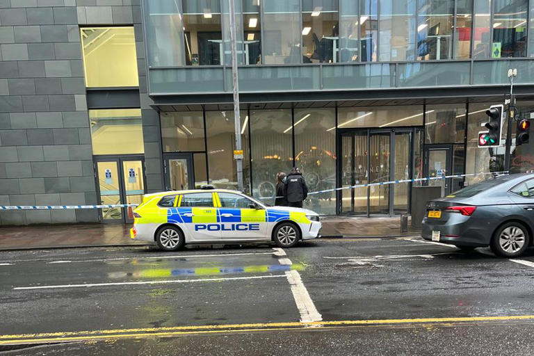 Police seal off busy Glasgow street as protesters smash front of building