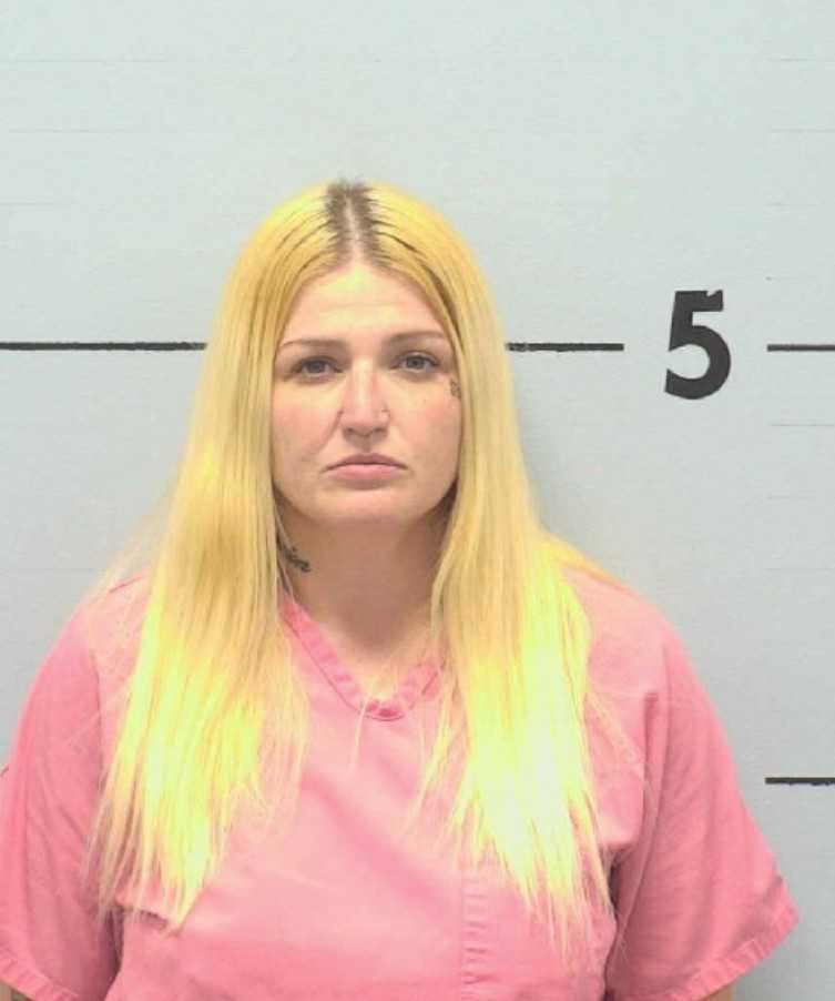 Woman arrested at gas station after shooting into occupied home ...
